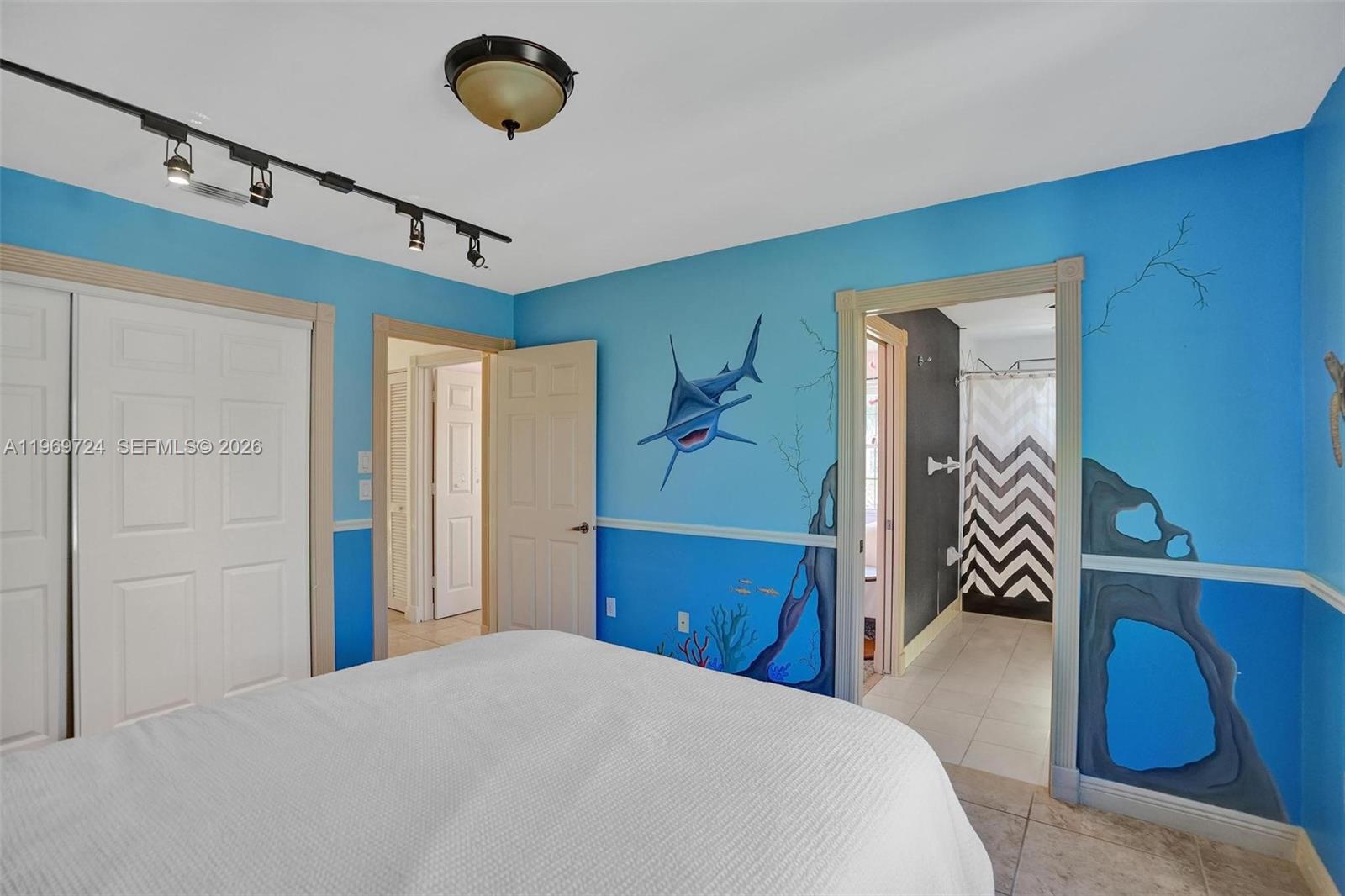 17431 Southwest 35th Street Miramar, FL 33029 - Photo 23 of 61 a bedroom with a bed and a chandelier