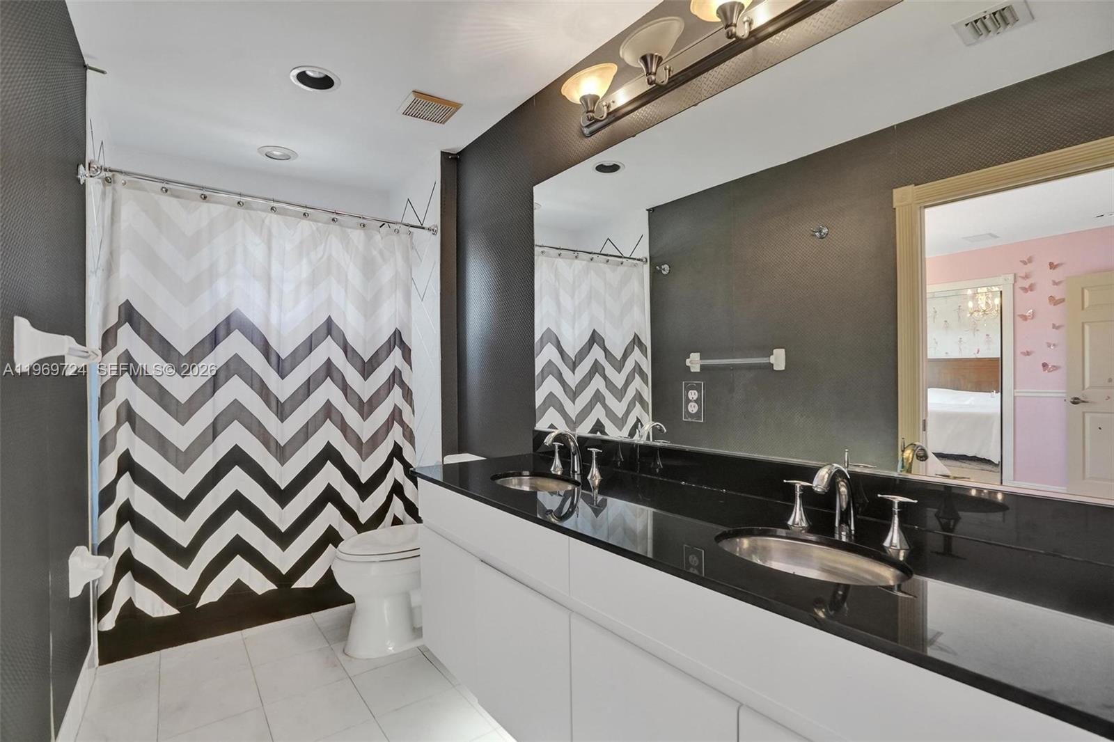 17431 Southwest 35th Street Miramar, FL 33029 - Photo 24 of 61 a bathroom with a double vanity sink and a mirror