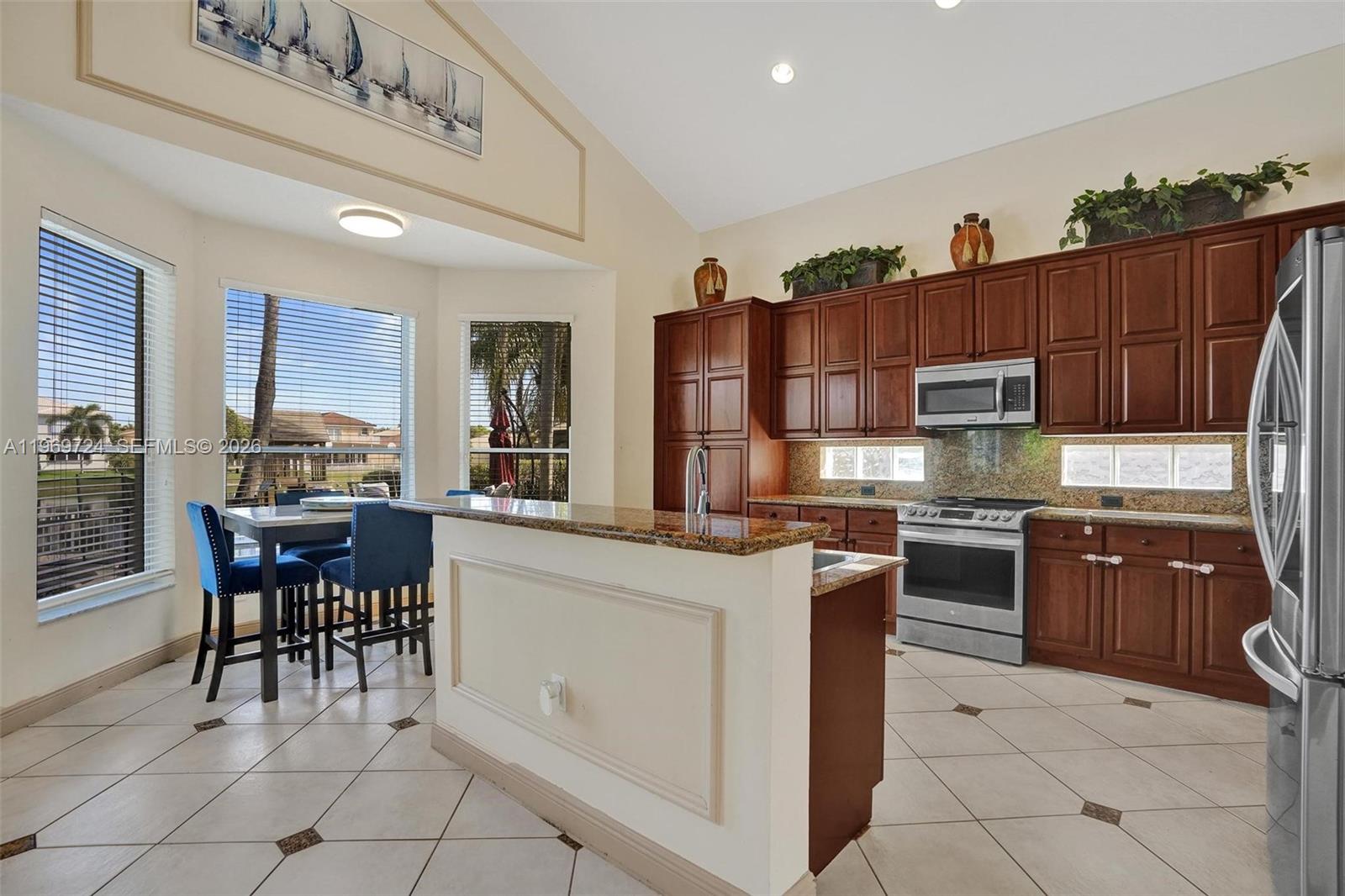17431 Southwest 35th Street Miramar, FL 33029 - Photo 36 of 61 a kitchen with stainless steel appliances granite countertop a stove top oven a sink dishwasher and a refrigerator