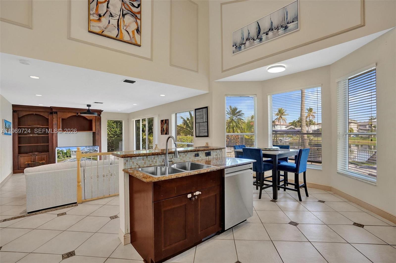 17431 Southwest 35th Street Miramar, FL 33029 - Photo 39 of 61 a dining hall with stainless steel appliances granite countertop a sink and a refrigerator