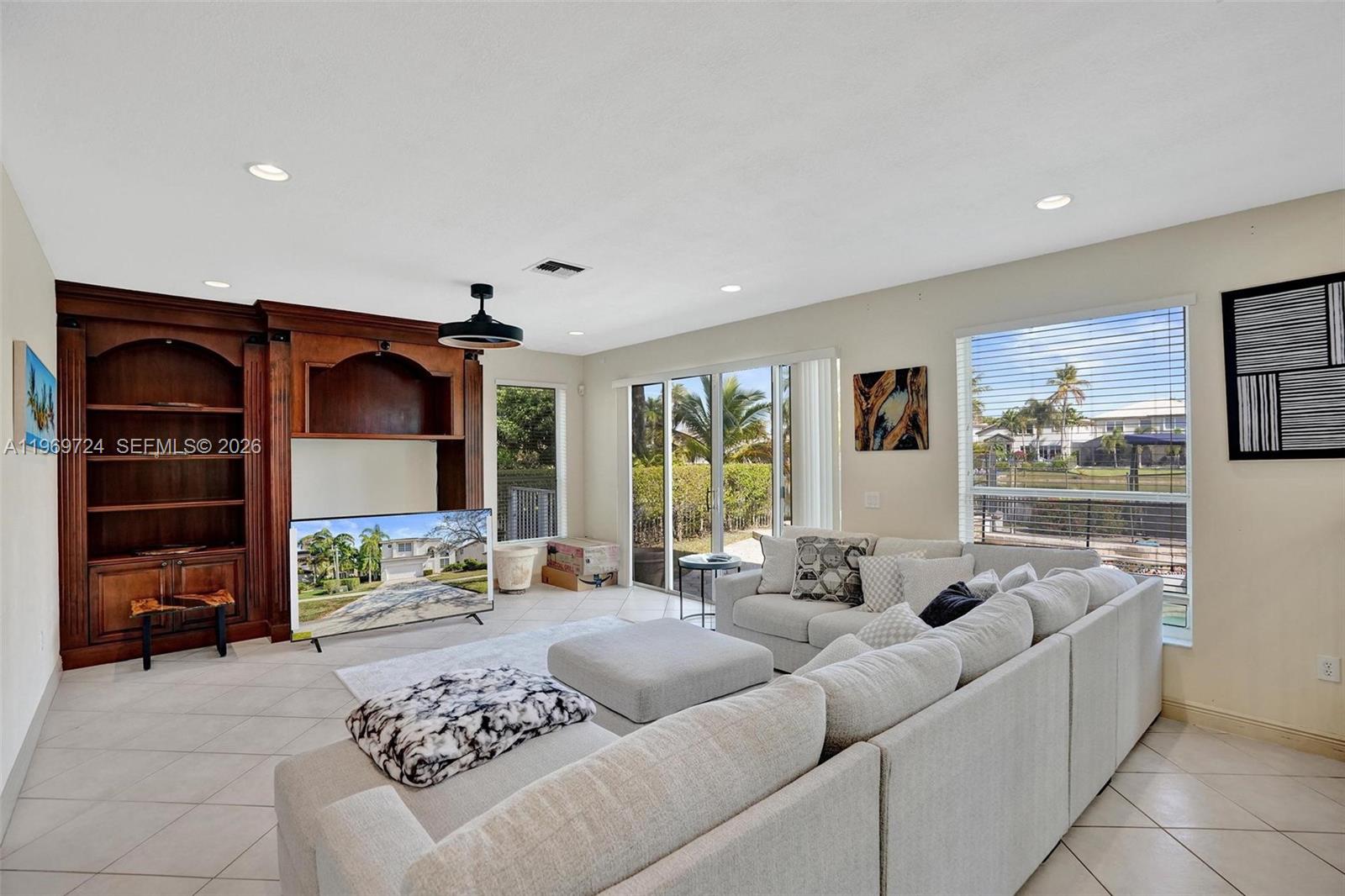 17431 Southwest 35th Street Miramar, FL 33029 - Photo 42 of 61 a living room with furniture and a flat screen tv