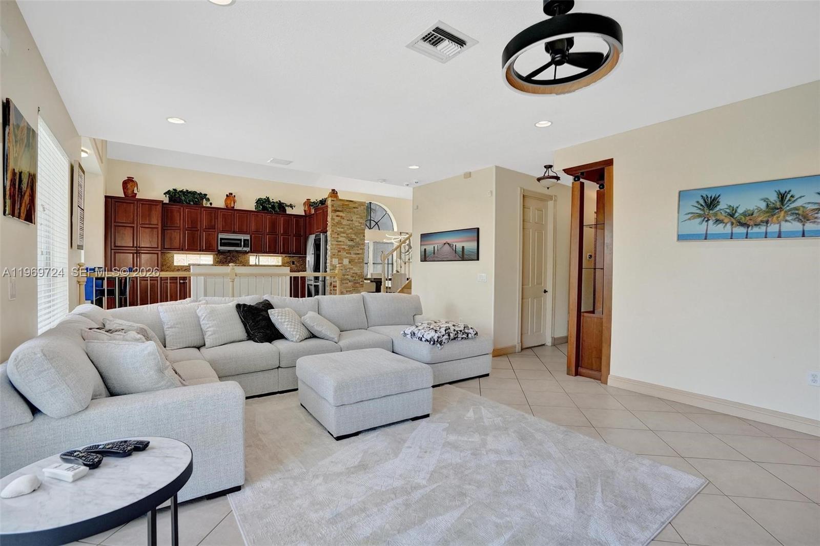 17431 Southwest 35th Street Miramar, FL 33029 - Photo 44 of 61 a living room with furniture a rug and a chandelier