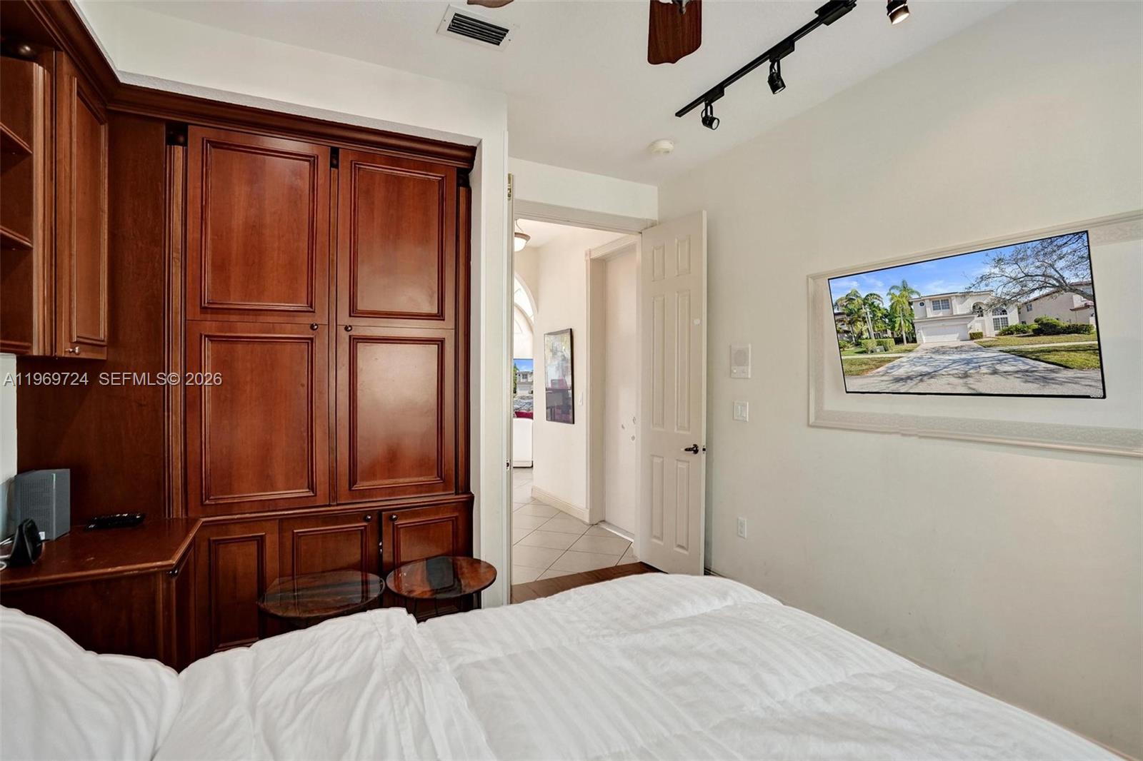 17431 Southwest 35th Street Miramar, FL 33029 - Photo 48 of 61 a bedroom with a bed and a painting on the wall