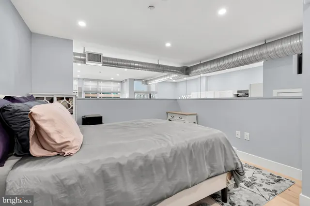 a bedroom with a bed and a chair