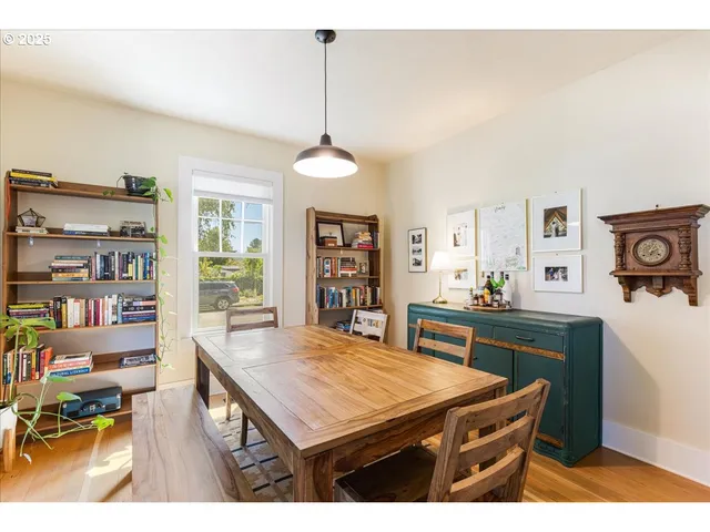 a room with furniture a bookshelf and a window