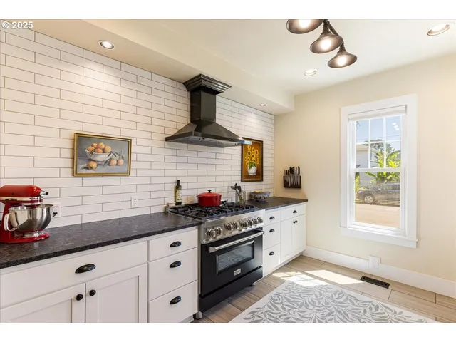 a kitchen with a sink cabinets and window
