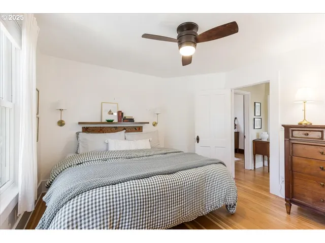 a bedroom with a bed and a ceiling fan