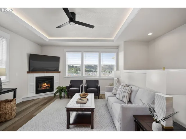 a living room with furniture a fireplace and a flat screen tv
