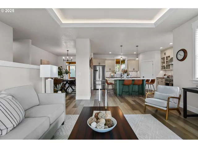 a living room with furniture and kitchen view