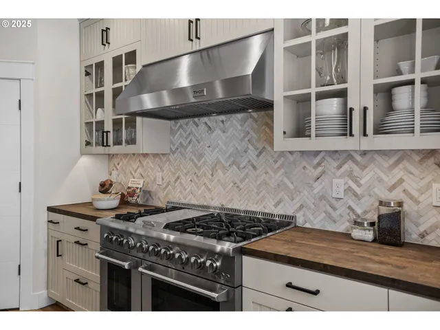 a kitchen with granite countertop a stove and a sink
