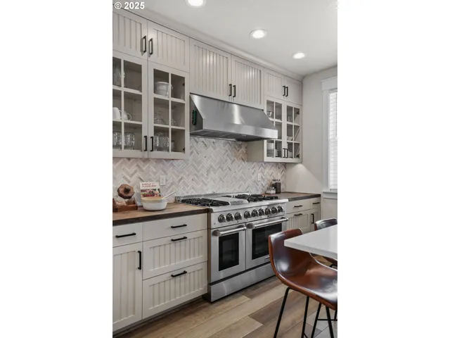 a kitchen with stainless steel appliances granite countertop a stove and a refrigerator