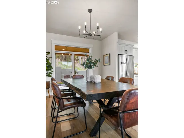 a view of a dining room with furniture and chandelier