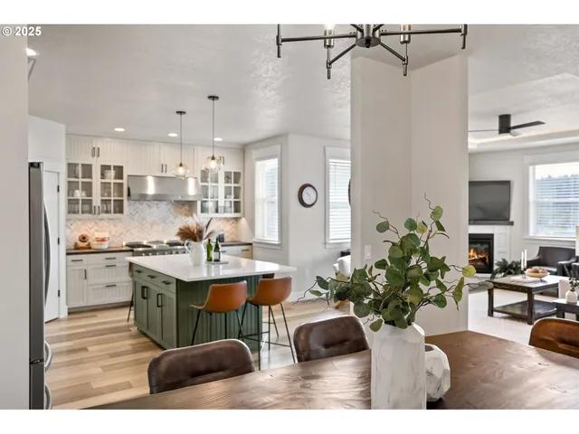 a dining room with kitchen island a counter top space a sink and cabinets