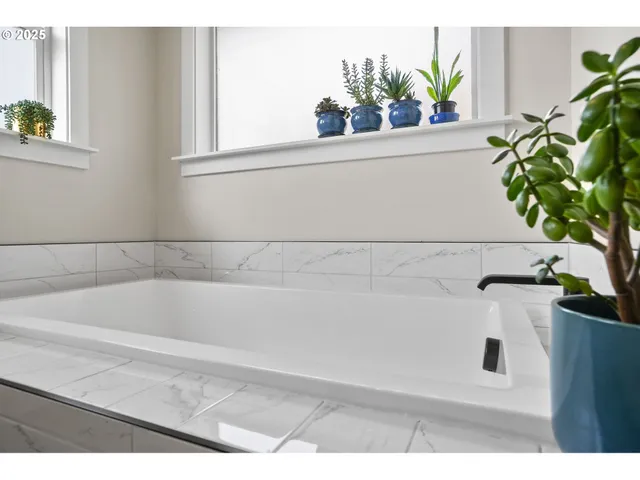 a kitchen with granite countertop a sink dishwasher a stove and a microwave oven