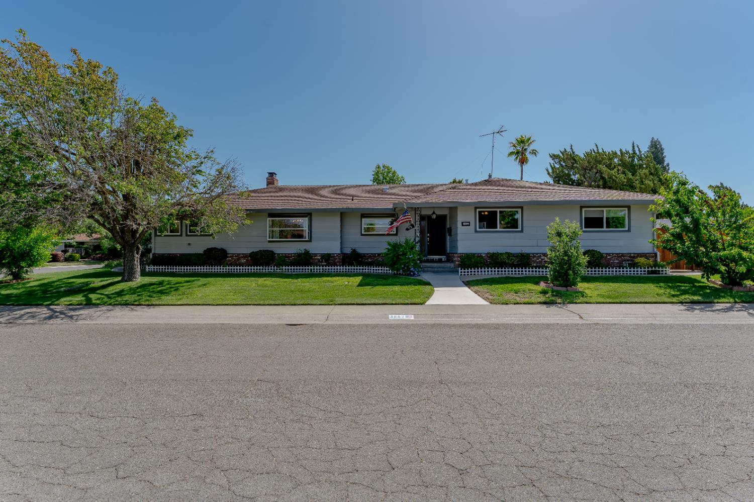 3862 Mission Avenue Carmichael, CA 95608 - Photo 1 of 1 a view of large house with a big yard and palm trees
