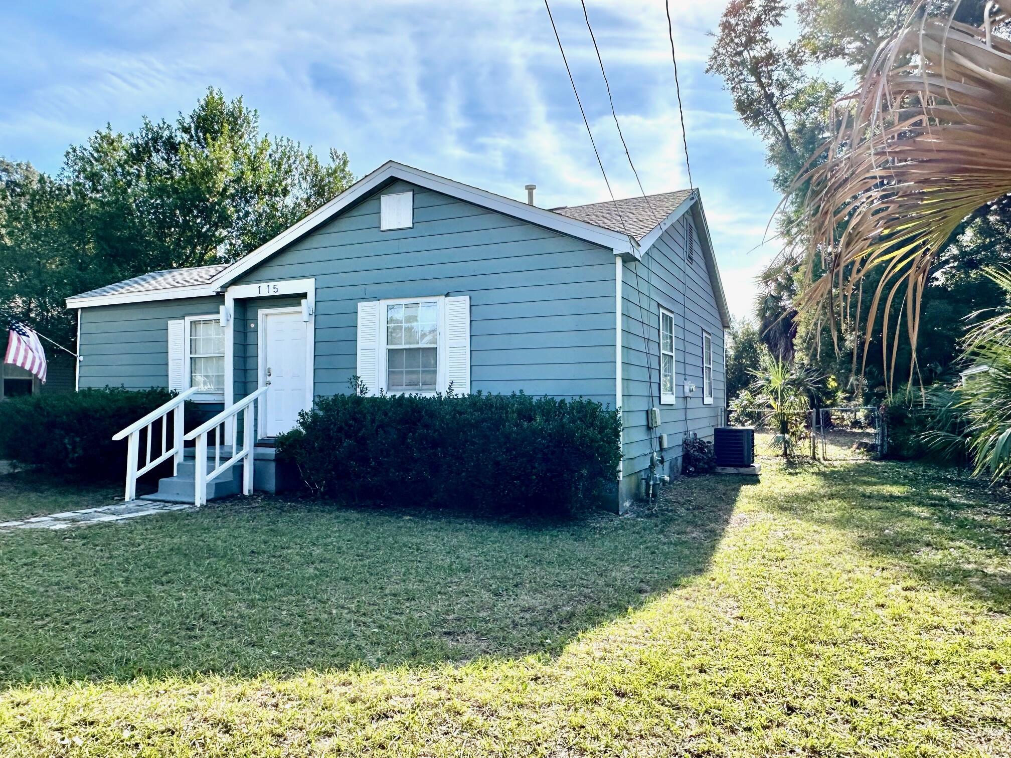 115 Milton Road Pensacola, FL 32507 - Photo 2 of 18 a view of backyard with potted plants and large tree