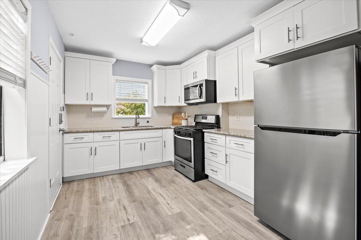 115 Milton Road Pensacola, FL 32507 - Photo 7 of 18 a kitchen with white cabinets and white appliances