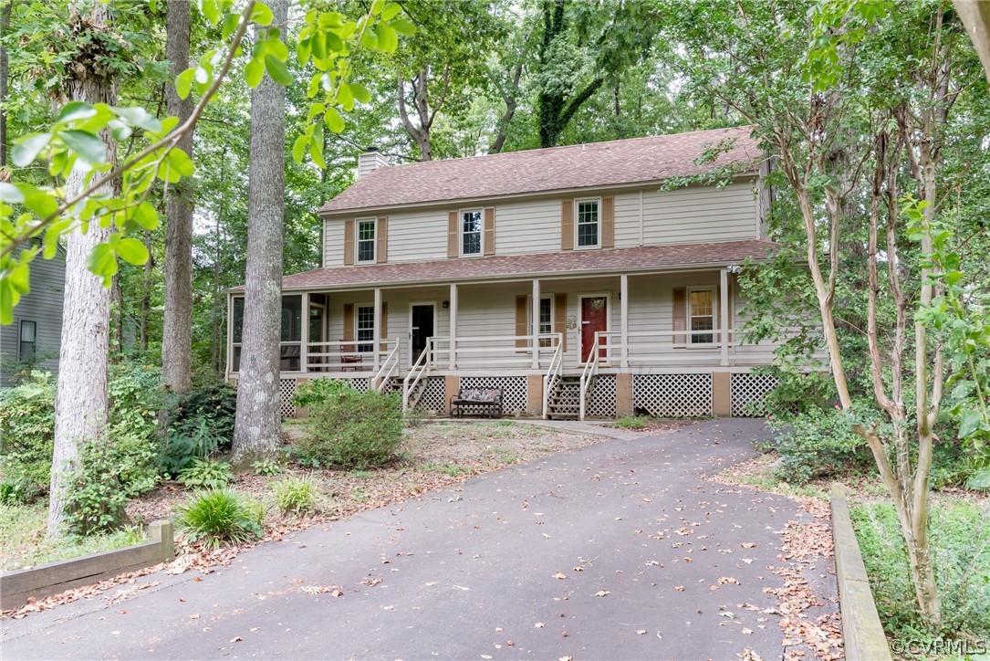 1400 Stone River Road North Chesterfield, VA 23235 - Photo 2 of 34 a view of a white house with large windows and a small yard