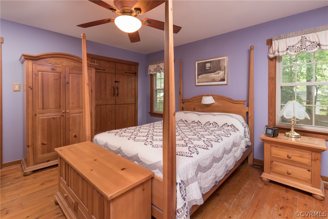 1400 Stone River Road North Chesterfield, VA 23235 - Photo 25 of 34 a bedroom with a bed and a dresser with wooden floor