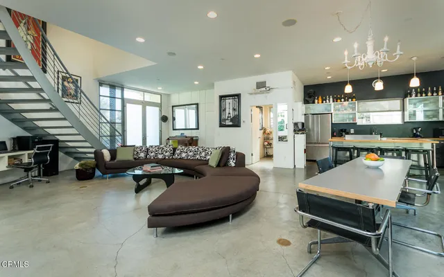a living room filled with furniture and a table