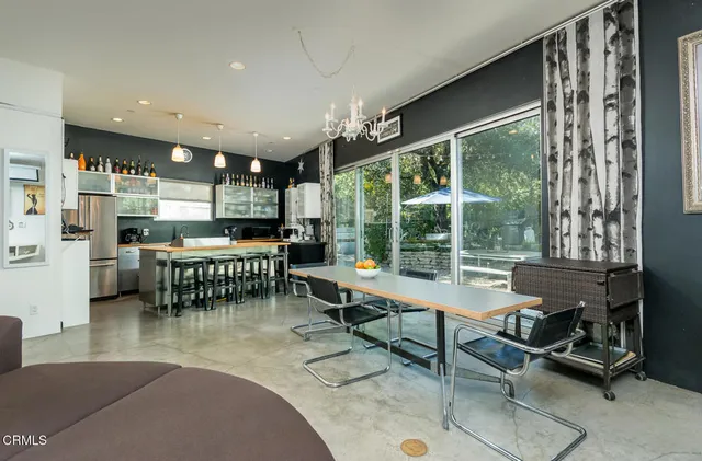 a large kitchen with a table chairs and a refrigerator