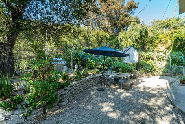 a view of a backyard with sitting area