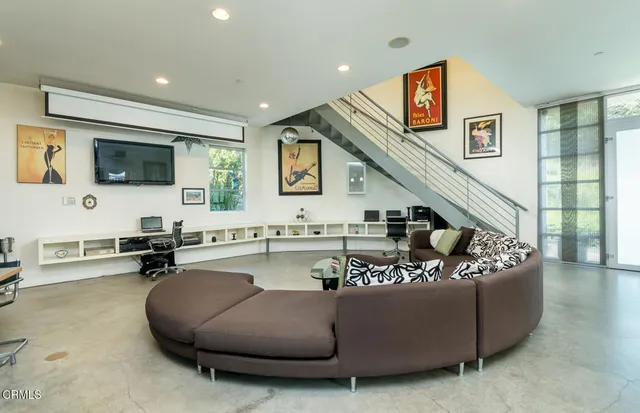 a dining room with wooden floor a chandelier a glass table and chairs