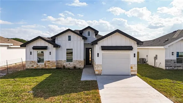 a front view of house with yard outdoor seating and barbeque oven