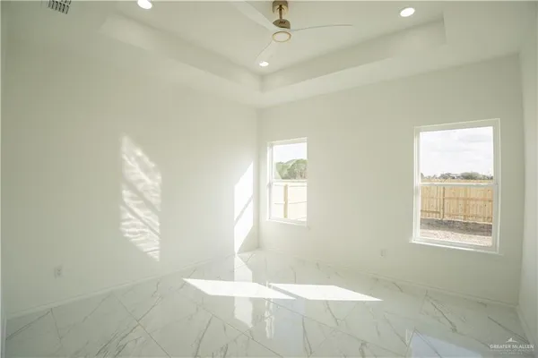 a large room with a large window and stainless steel appliances