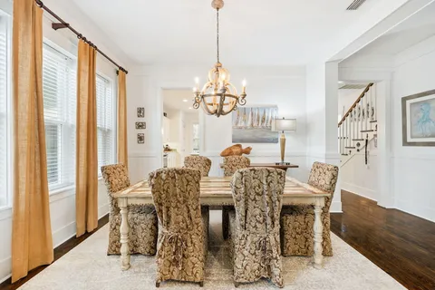 a living room with furniture a flat screen tv and a large window