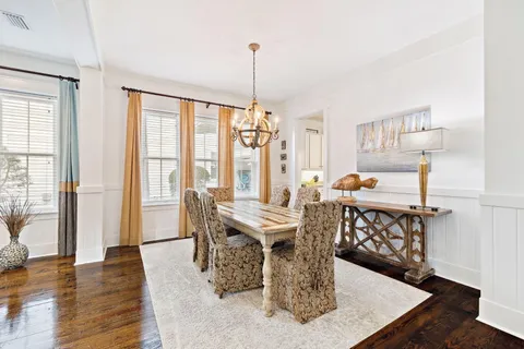 a large kitchen with cabinets wooden floor and stainless steel appliances