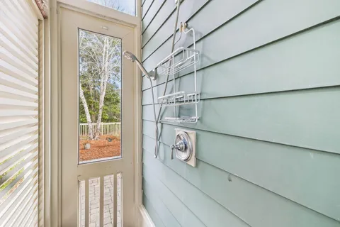 a spacious bathroom with stainless steel appliances granite countertop a sink and a bathtub