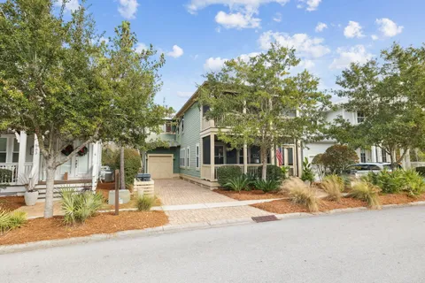 an aerial view of residential house with outdoor space and trees all around
