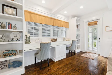 a living room with furniture a flat screen tv and a large window