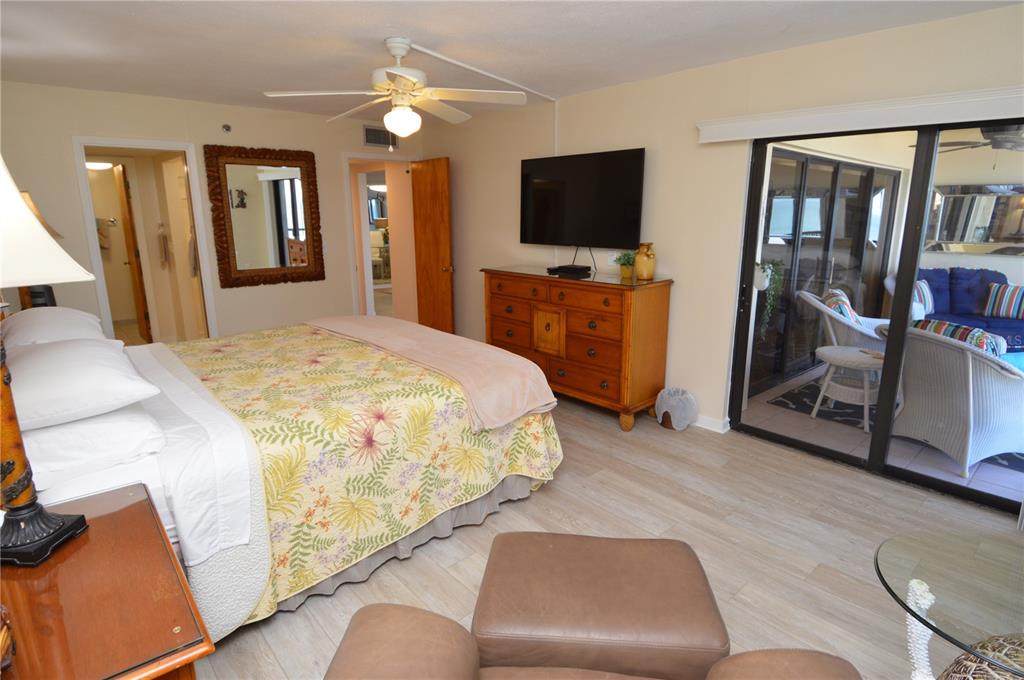 900 Gulf Boulevard, Unit 907 Indian Rocks Beach, FL 33785 - Photo 37 of 88 a spacious bedroom with a bed and a flat screen television