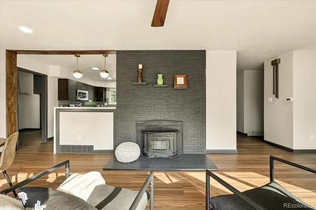 a kitchen with kitchen island granite countertop stainless steel appliances cabinets a sink and a window