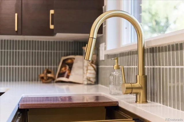 a kitchen with stainless steel appliances kitchen island granite countertop a refrigerator a sink a stove and island