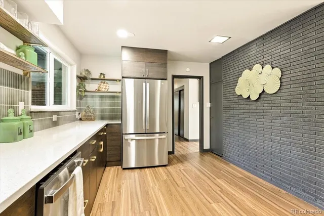 a kitchen with a table chairs sink and cabinets