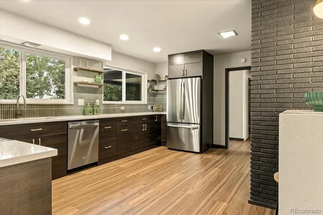 a view of a kitchen with wooden floor and cabinets