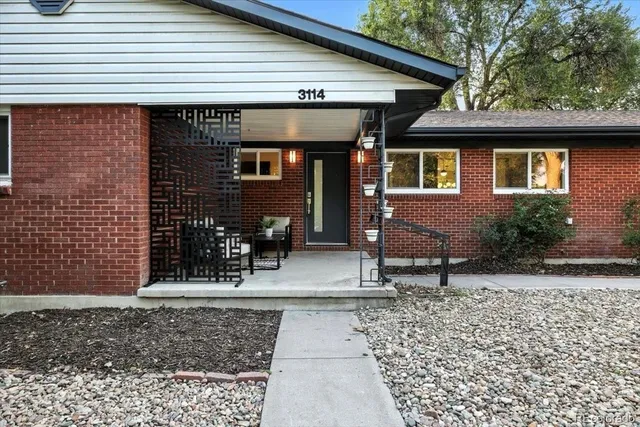 a backyard of a house with outdoor seating