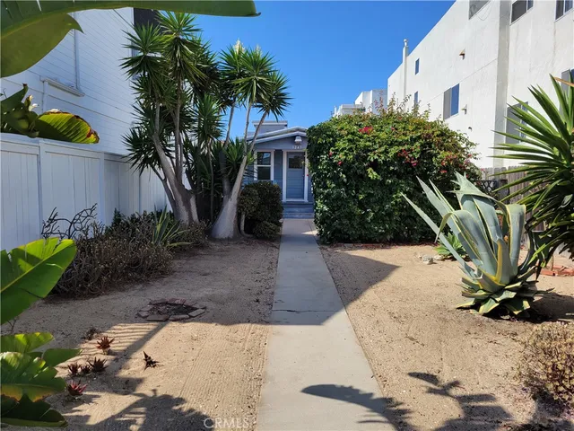 a kitchen with stainless steel appliances a refrigerator a stove a sink and a refrigerator