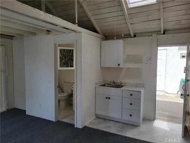 a bathroom with a window a toilet and a sink