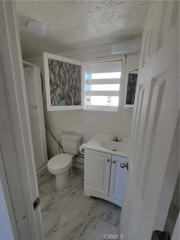 a view of a livingroom with an empty space and a window