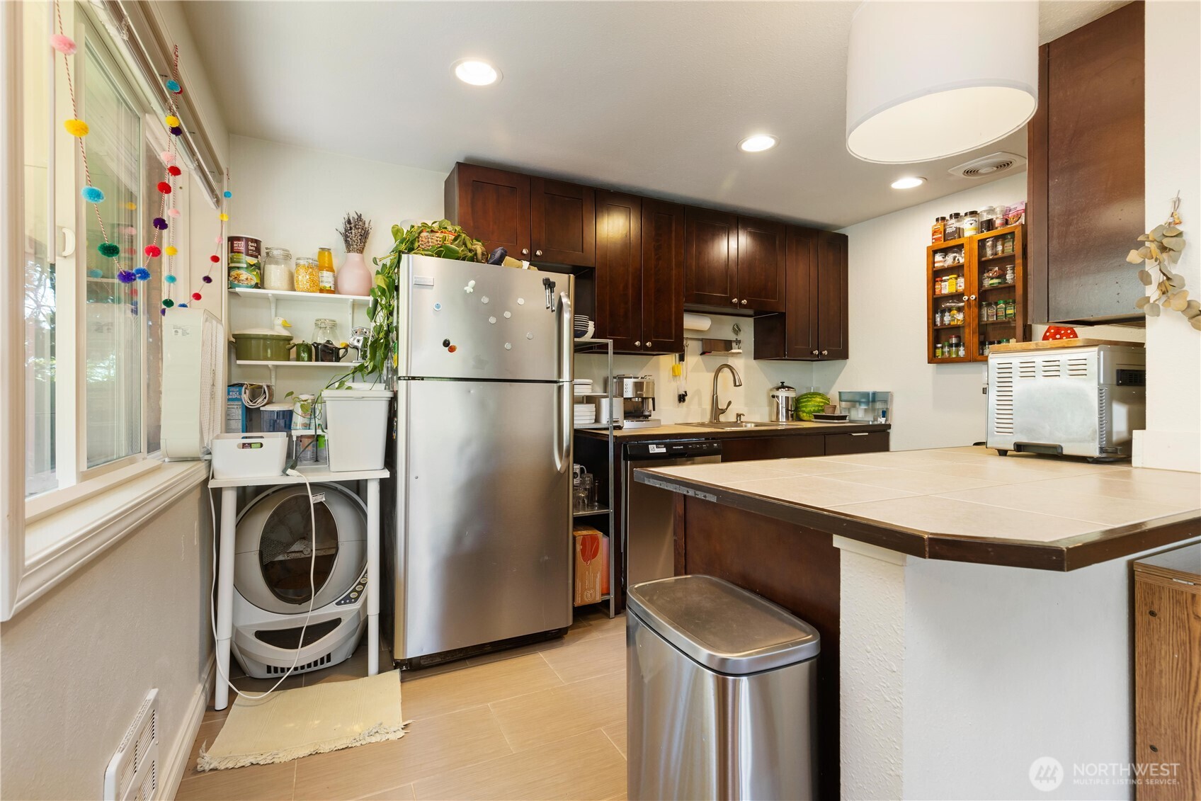 7343 35th Avenue Southwest Seattle, WA 98126 - Photo 11 of 36 a kitchen with a refrigerator and a sink