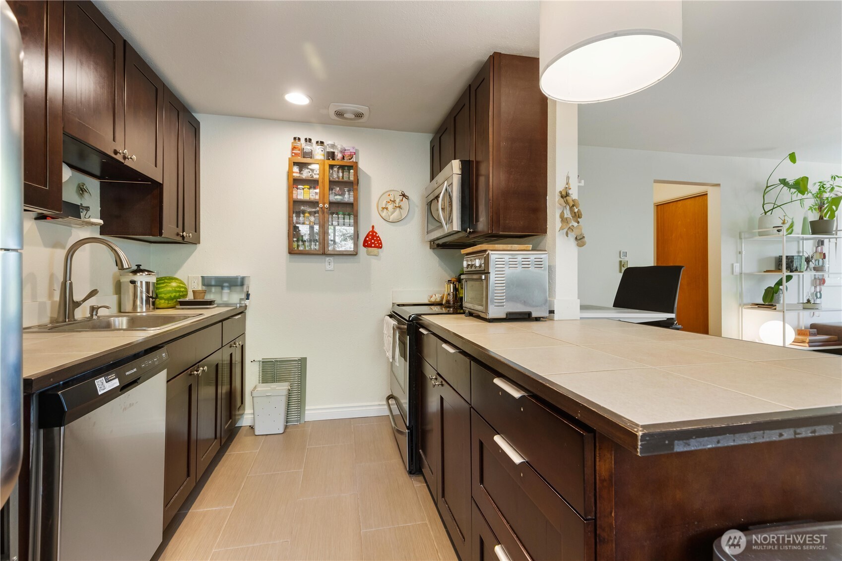 7343 35th Avenue Southwest Seattle, WA 98126 - Photo 12 of 36 a kitchen with a sink stove and microwave
