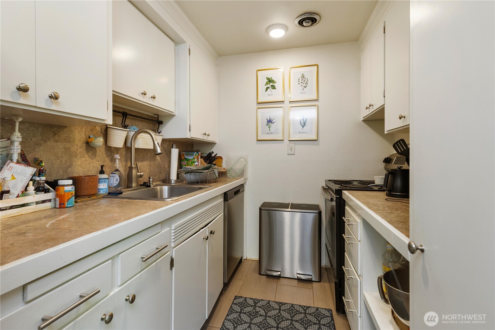 7343 35th Avenue Southwest Seattle, WA 98126 - Photo 19 of 36 a kitchen with stainless steel appliances granite countertop a sink a stove and a refrigerator