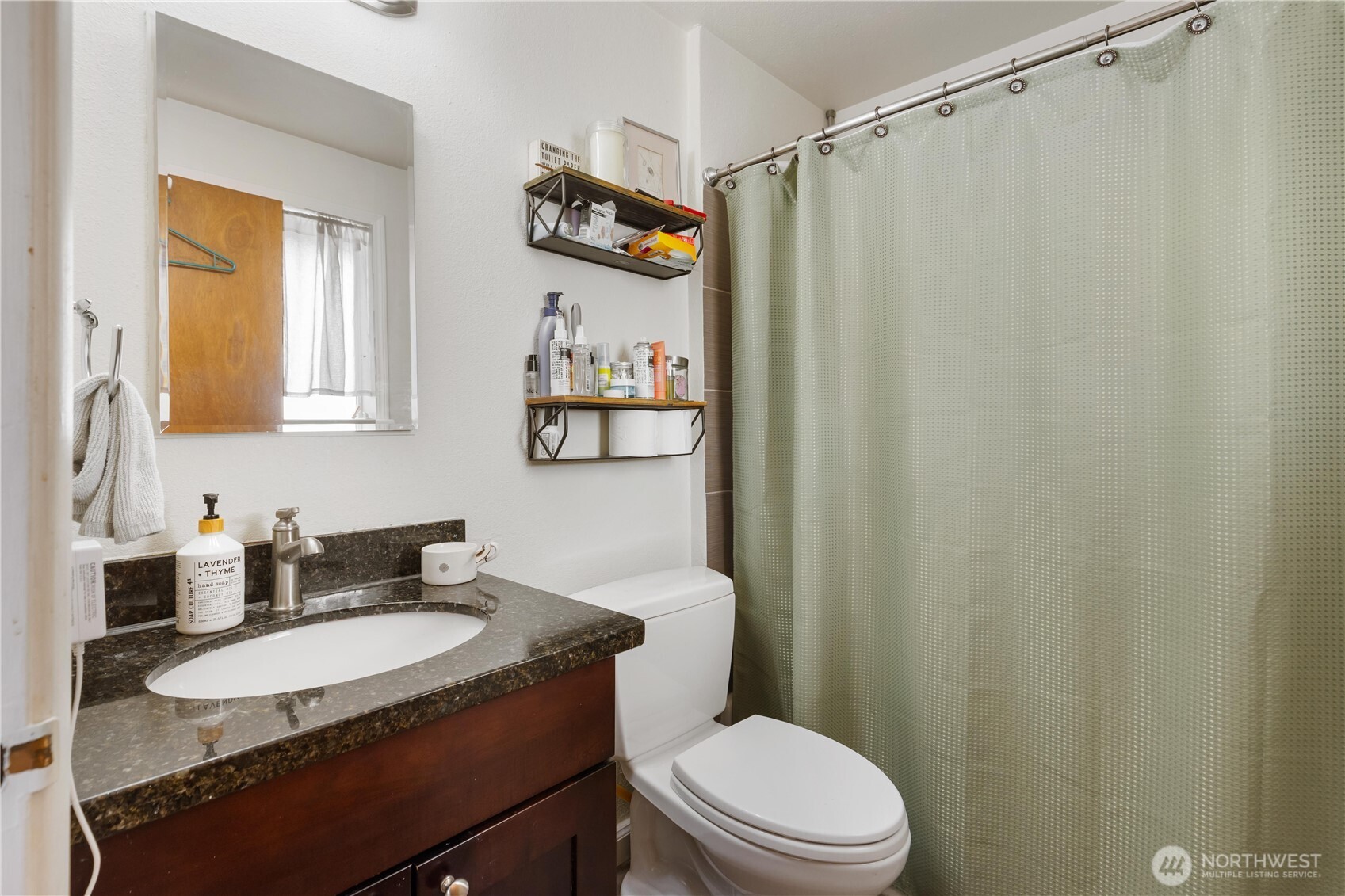 7343 35th Avenue Southwest Seattle, WA 98126 - Photo 20 of 36 a bathroom with a granite countertop sink toilet and shower