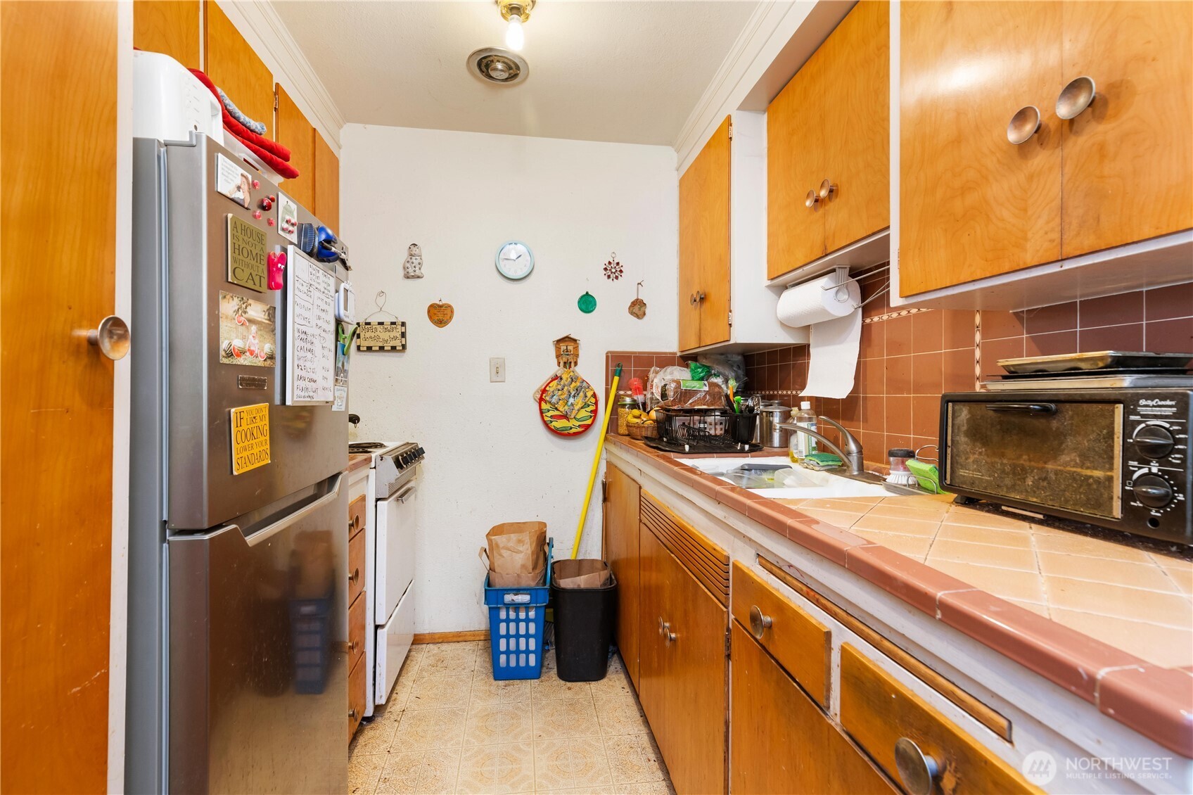 7343 35th Avenue Southwest Seattle, WA 98126 - Photo 24 of 36 a kitchen with stainless steel appliances a sink and a refrigerator