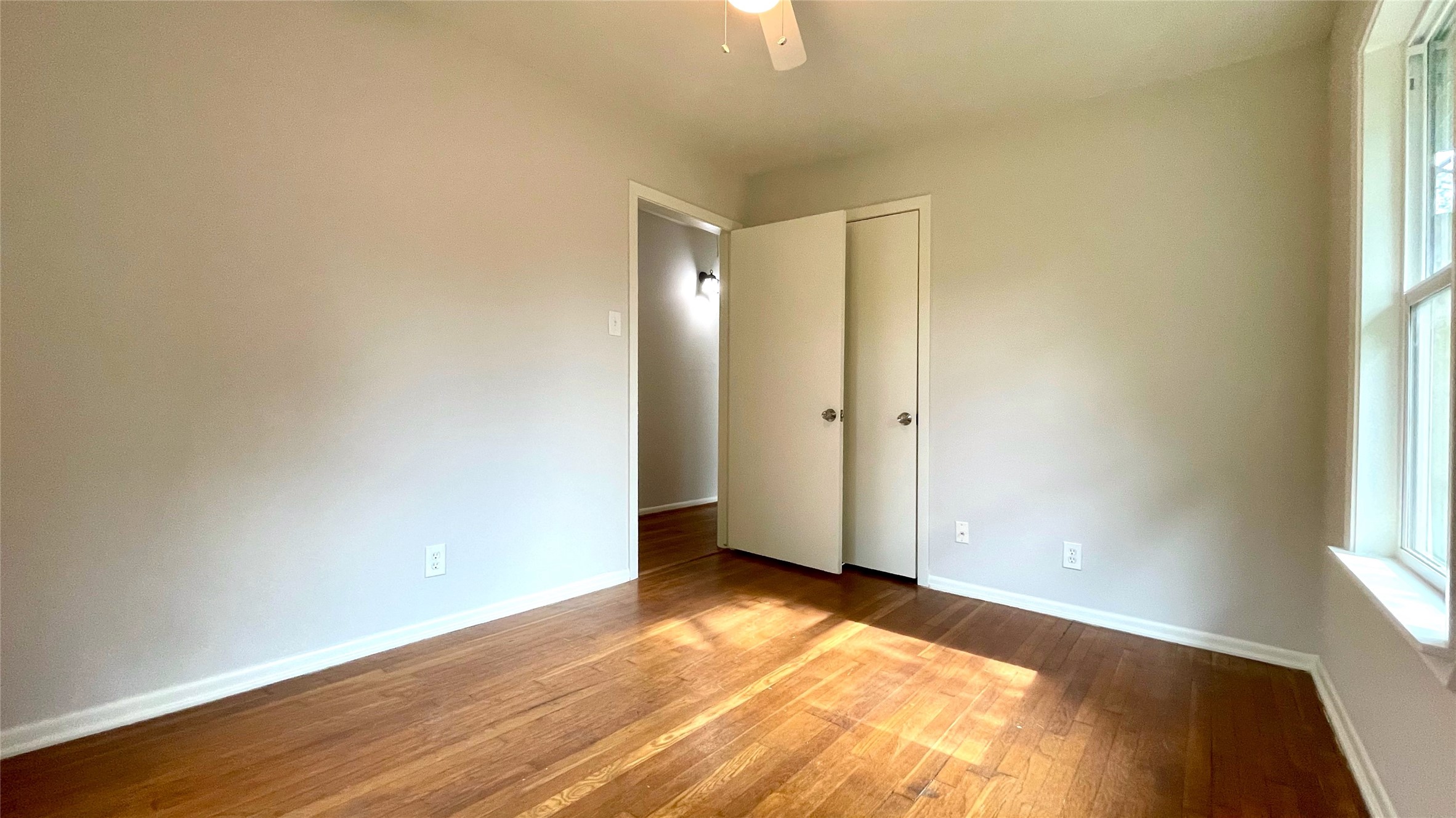 5905 Darnell Street Houston, TX 77074 - Photo 27 of 34 an empty room with wooden floor and windows