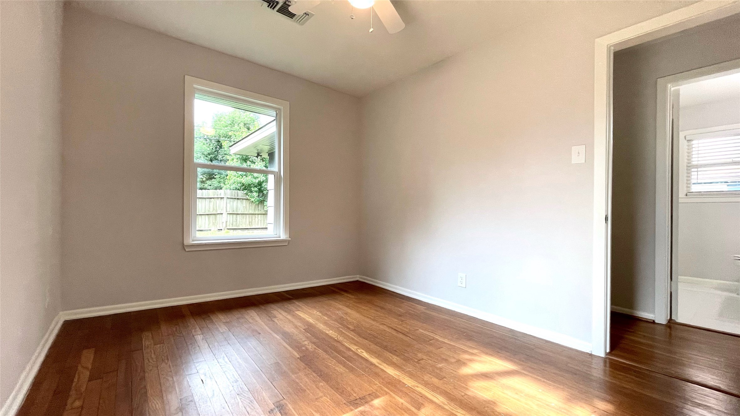 5905 Darnell Street Houston, TX 77074 - Photo 28 of 34 an empty room with wooden floor and windows